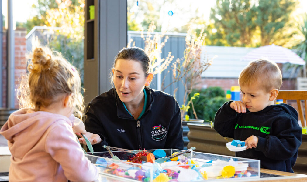 Children and educator playing on the deck outside at Lochinvar early education centre