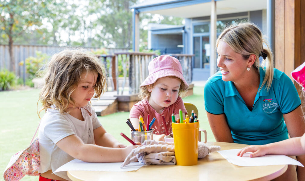 Preschool aged children drawing with educator at Branxton early education centre