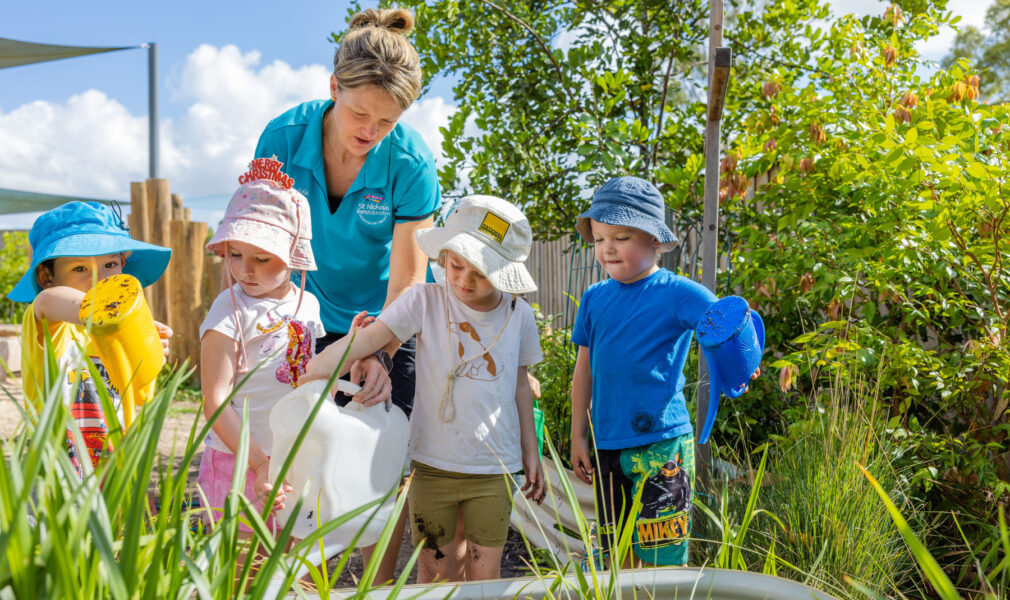 Children and educator tending to gardens at Branxton early education centre