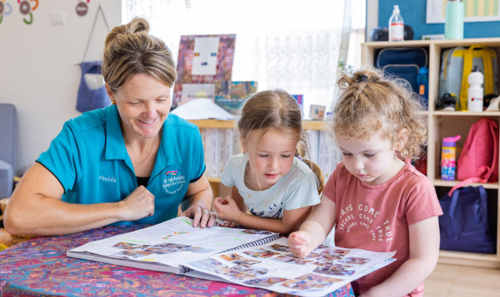 Children and educator reading a floorbook