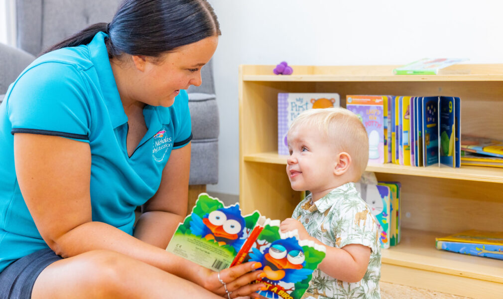 Child and educator reading at Chisholm early education centre