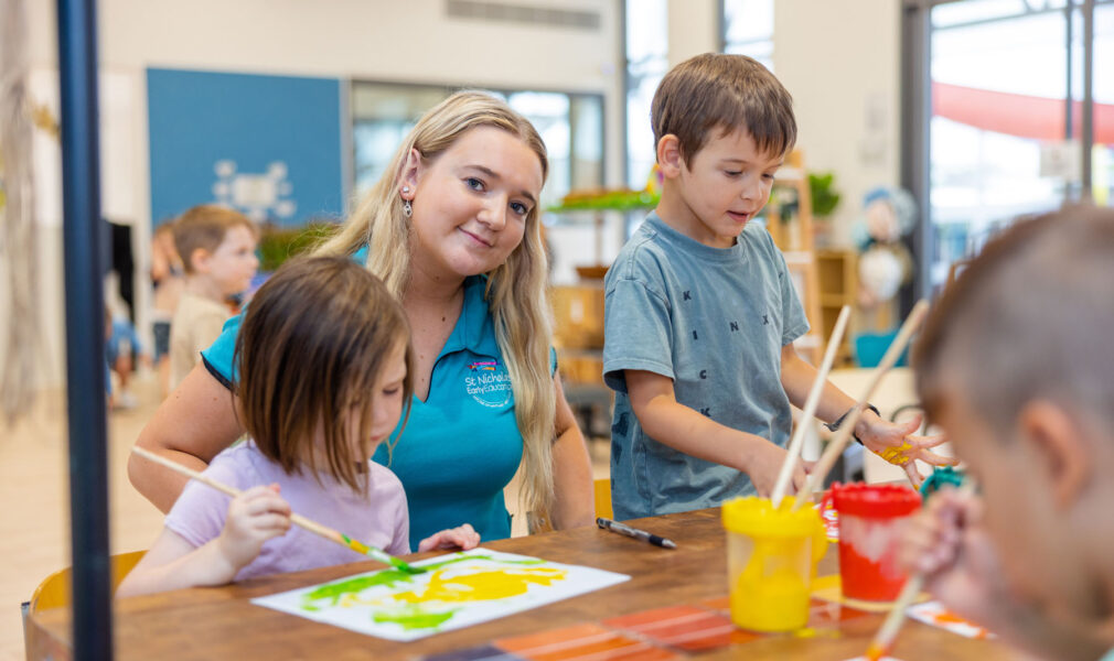 Children and educator painting at Chisholm early education centre