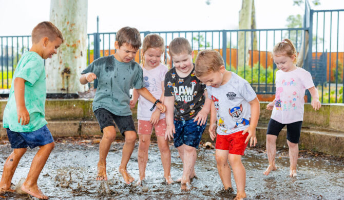 Children playing in the mud pit at Chisholm early education centre