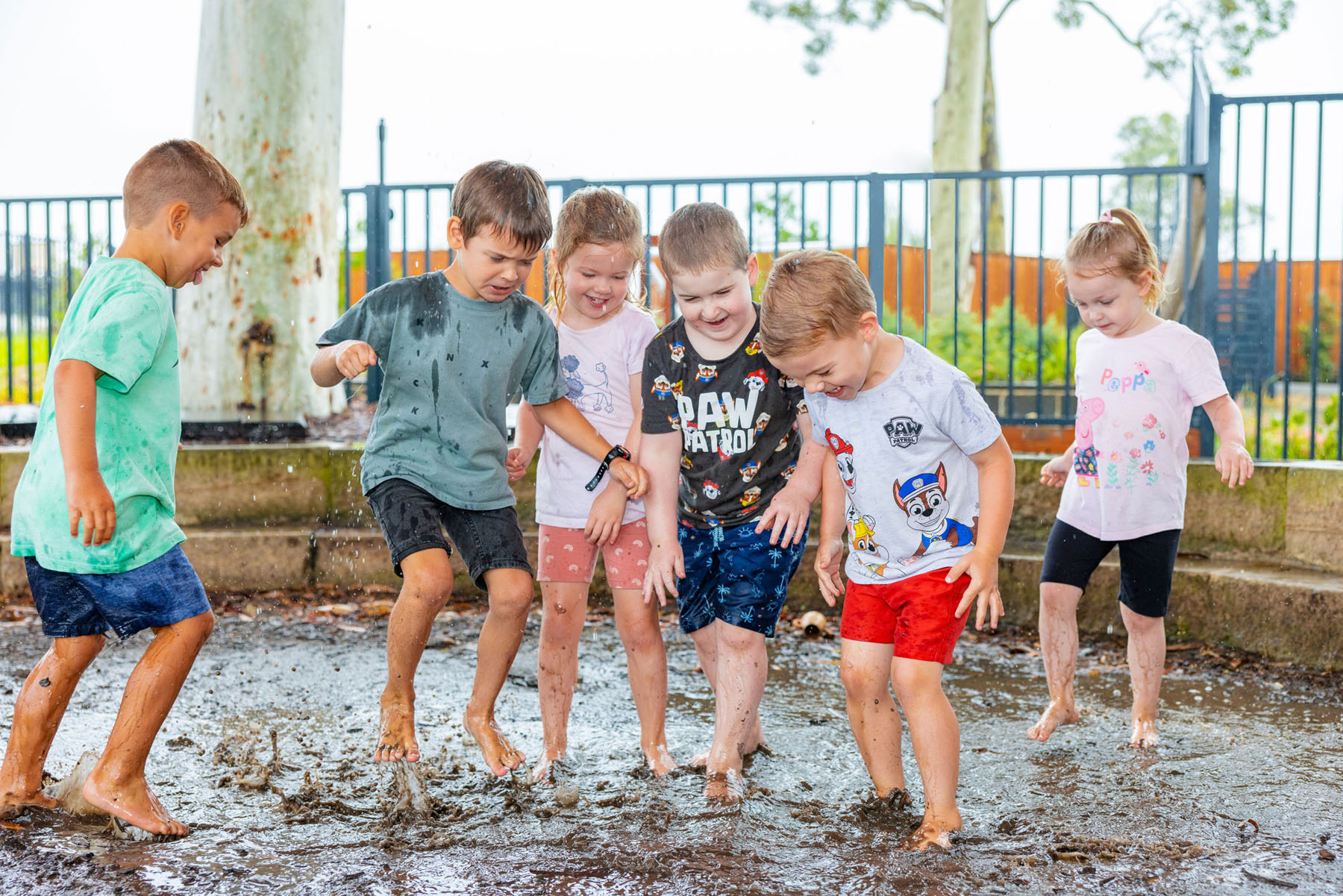 Children playing in the mud pit at Chisholm early education centre