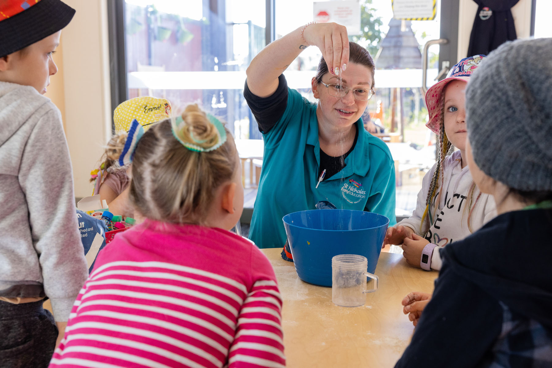 Children and educator making playdough at Gillieston Heights early education centre