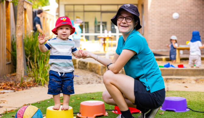 Child and educator playing outside at Maitland early education centre