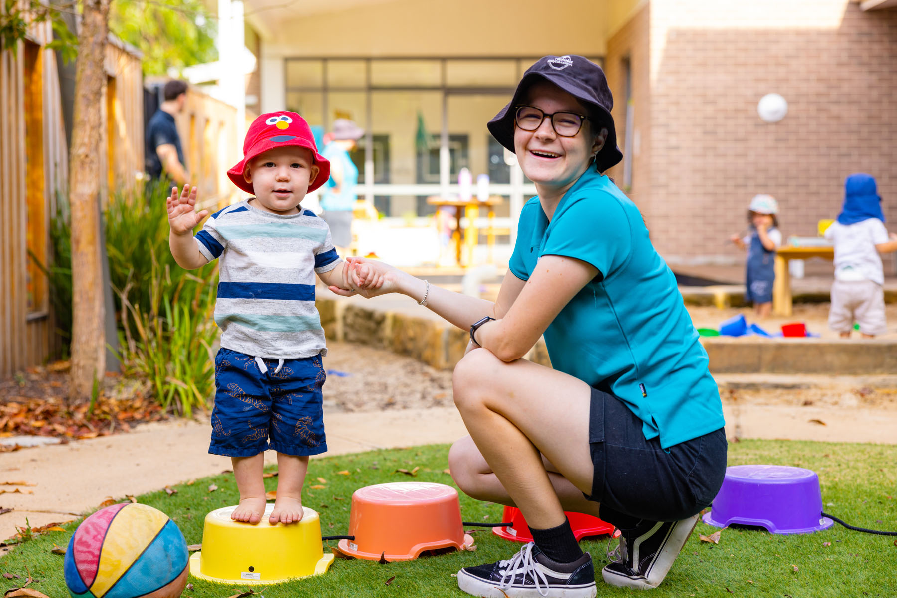 Child and educator playing outside at Maitland early education centre