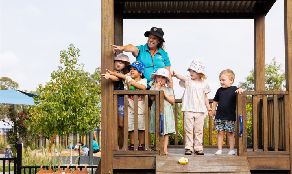 Children and educator on climbing structure outside at Muswellbrook early education centre