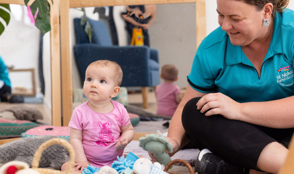 Baby and educator interacting inside at Muswellbrook early education centre