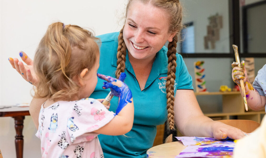 Child and educator painting together at Muswellbrook early education centre