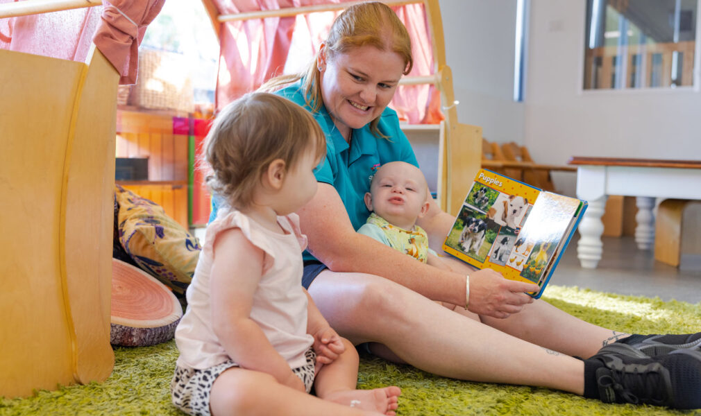 Children and educator reading together at Raymond Terrace early education centre
