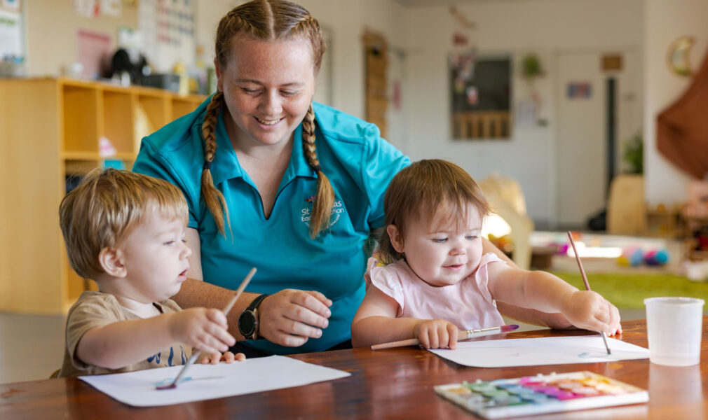 Children and educator painting together at Raymond Terrace early education centre