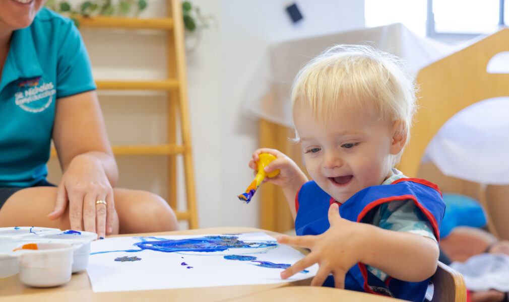 Child and educator painting together at Raymond Terrace early education centre