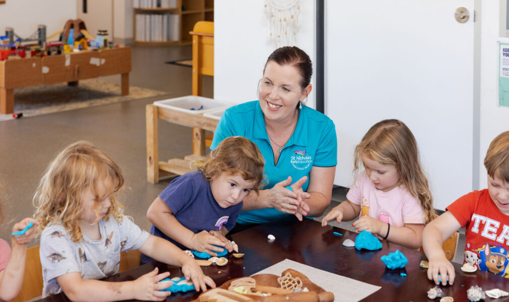 Educator and children playing with play dough together at Raymond Terrace early education centre