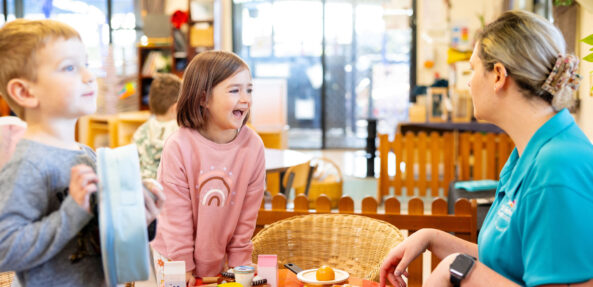 Children and educator engaged in dramatic playing inside at Singleton early education centre