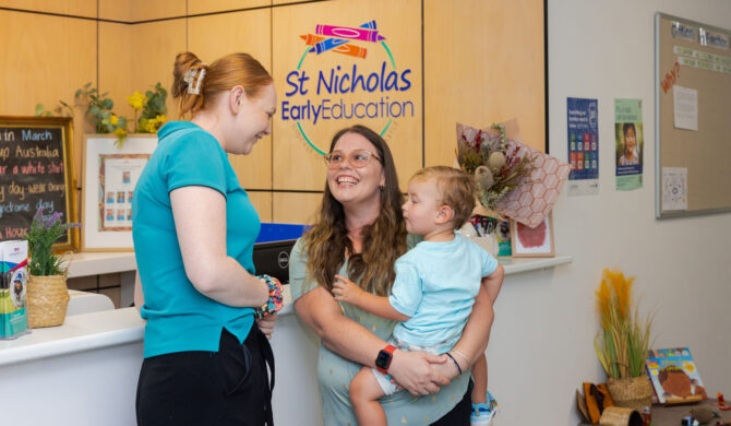 A St Nicholas educator interacting with a parent/carer and preschool child