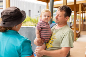 St Nicholas educator talking to a parent and enrolled child