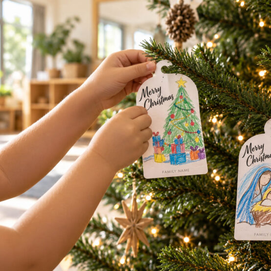 Preschool hands hang Christmas tags